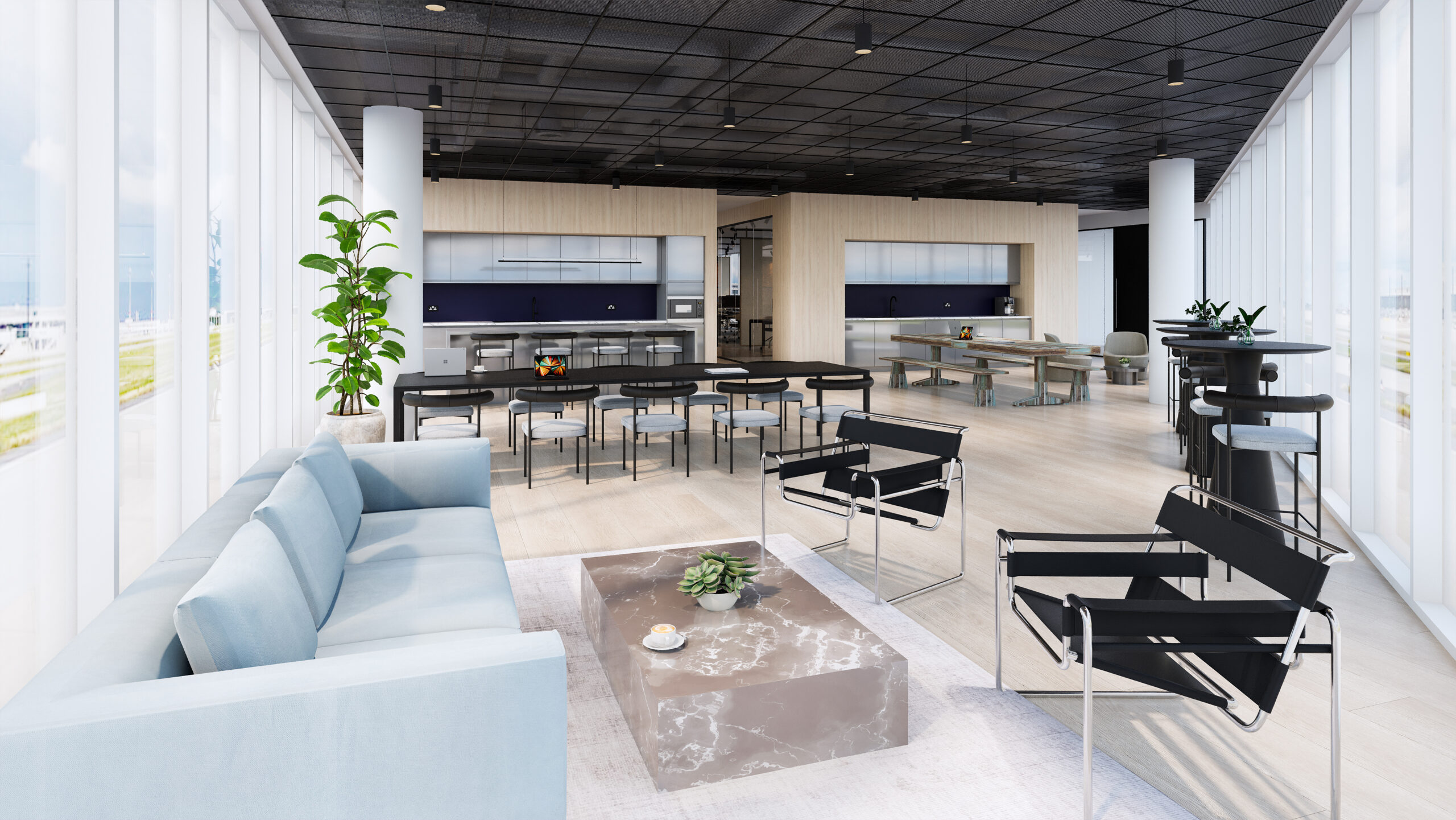 Modern office lounge with a light blue sofa, black chairs, dining tables, and large windows.